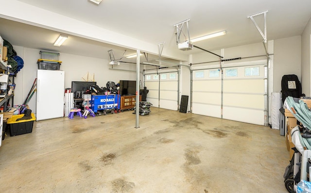 1480 Pilgrim Rd, Goode, VA 24556 - garage featuring freestanding refrigerator and a garage door opener