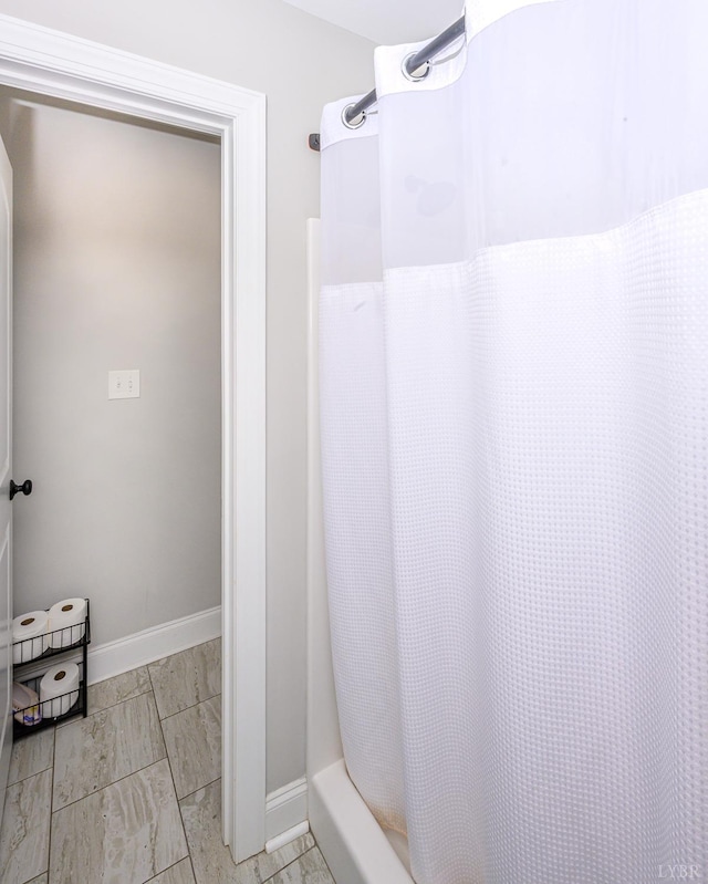 1480 Pilgrim Rd, Goode, VA 24556 - bathroom featuring marble look tile flooring, baseboards, and curtained shower