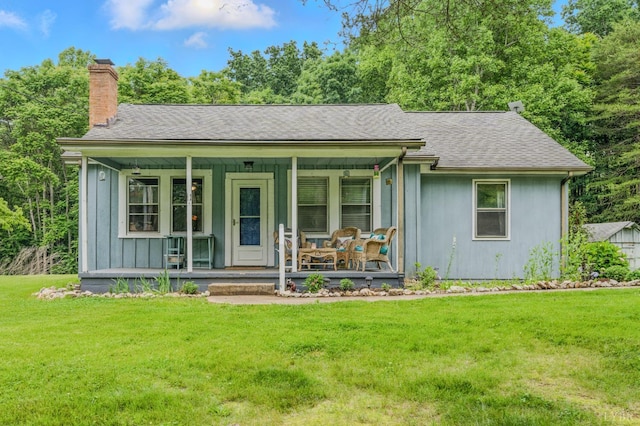2086 Marshall Mill Rd, Gladys, VA 24554 - view of front facade with a chimney, covered porch, a front yard, and a shingled roof