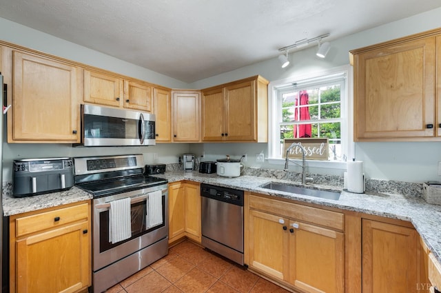 1053 Hupps Hill Ln, Forest, VA 24551 - kitchen with stainless steel appliances, a sink, light tile patterned flooring, light stone counters, and rail lighting