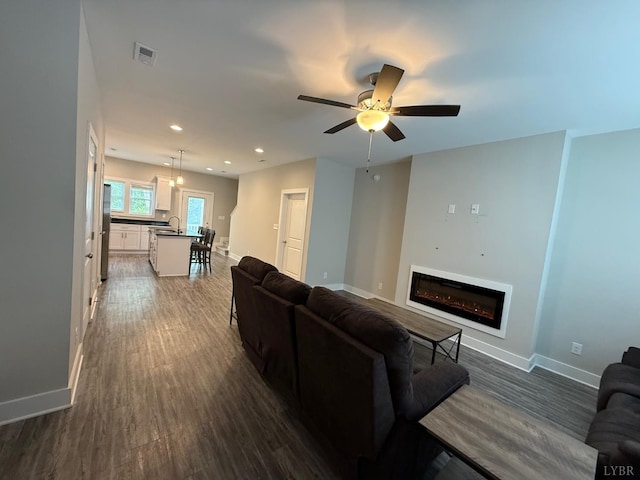 49 Cuddington Ln, Lynchburg, VA 24501 - living room with dark wood-style flooring, a glass covered fireplace, baseboards, ceiling fan, and recessed lighting