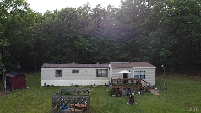 134 Napier Dr, Concord, VA 24538 - rear view of house with a wooden deck, a lawn, and a view of trees