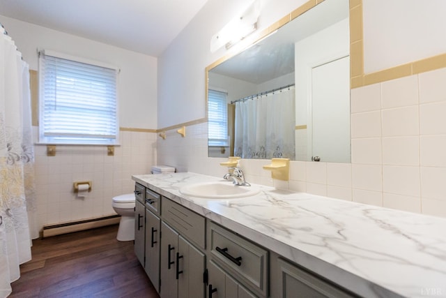 1592 Purdum Mill Rd, Appomattox, VA 24522 - bathroom with a baseboard radiator, tile walls, healthy amount of natural light, wood finished floors, and vanity