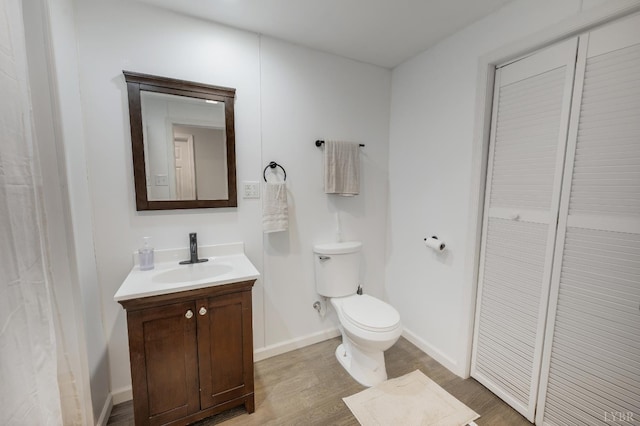 343 Soybean Dr, Appomattox, VA 24522 - bathroom with vanity, toilet, wood finished floors, and baseboards