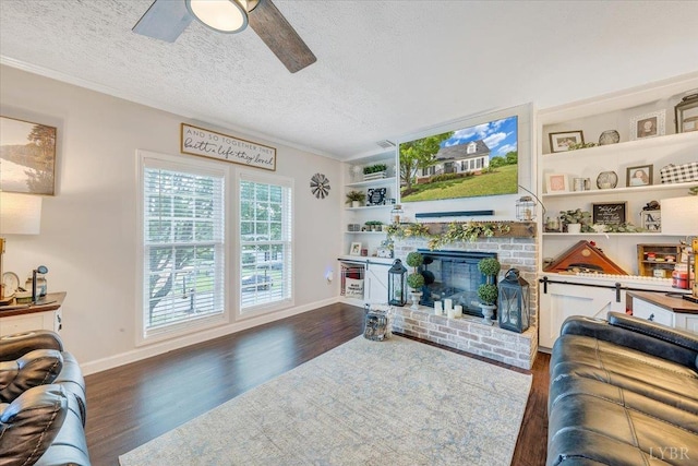 1028 Park Mountain Ter, Huddleston, VA 24104 - living area featuring wood finished floors, a ceiling fan, a fireplace, baseboards, and a textured ceiling