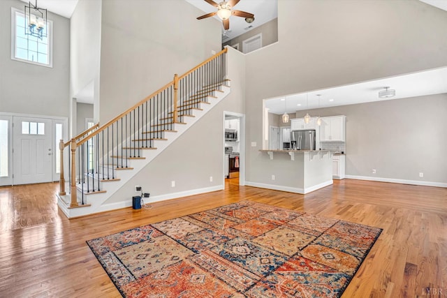 238 Ridgeline Dr, Concord, VA 24538 - foyer entrance featuring a towering ceiling, baseboards, stairs, and light wood-style flooring