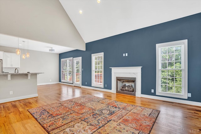 238 Ridgeline Dr, Concord, VA 24538 - unfurnished living room with high vaulted ceiling, light wood-style flooring, a fireplace, baseboards, and recessed lighting