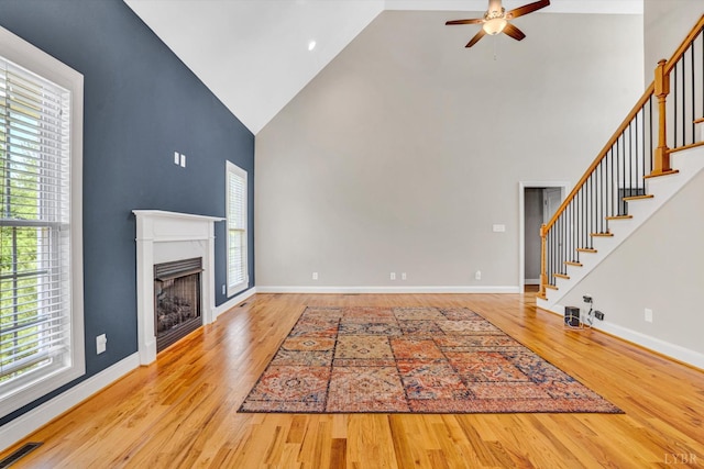 238 Ridgeline Dr, Concord, VA 24538 - unfurnished living room featuring high vaulted ceiling, ceiling fan, stairs, wood finished floors, and a fireplace
