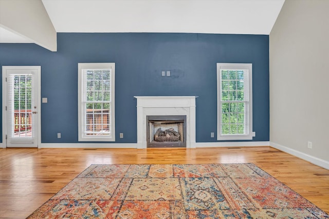 238 Ridgeline Dr, Concord, VA 24538 - unfurnished living room with wood finished floors, lofted ceiling, a fireplace, and baseboards