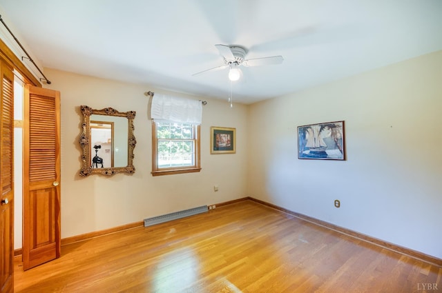 1129 Croft Ln, Bedford, VA 24523 - unfurnished bedroom with a baseboard heating unit, light wood-type flooring, baseboards, a ceiling fan, and a closet