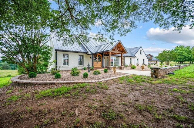 7845 Bear Creek Rd, Gladys, VA 24554 - modern inspired farmhouse featuring a standing seam roof, brick siding, and a metal roof