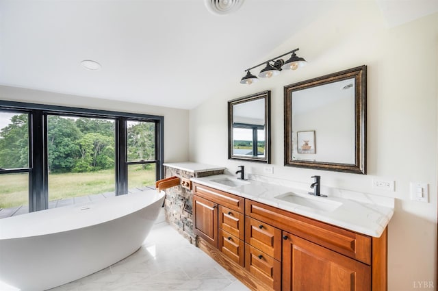 7845 Bear Creek Rd, Gladys, VA 24554 - bathroom with double vanity, lofted ceiling, a soaking tub, marble finish floors, and recessed lighting