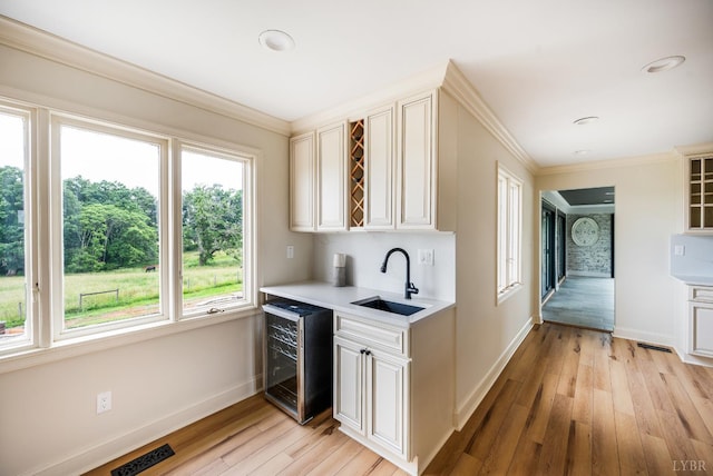 7845 Bear Creek Rd, Gladys, VA 24554 - bar featuring wine cooler, light wood finished floors, ornamental molding, and recessed lighting