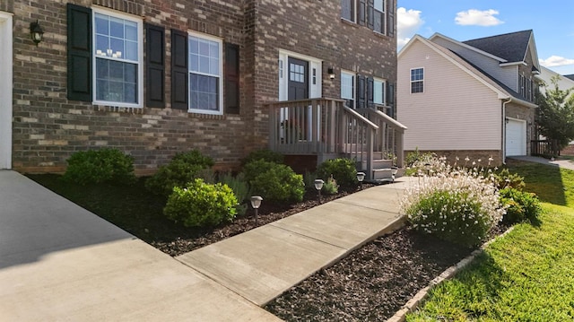 189 Traverse Dr, Evington, VA 24550 - view of exterior entry featuring brick siding, a garage, and driveway