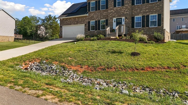 189 Traverse Dr, Evington, VA 24550 - view of front of home featuring brick siding, concrete driveway, and roof mounted solar panels
