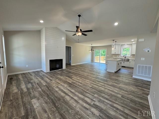 2304 Spring Grove Rd, Spout Spring, VA 24593 - unfurnished living room featuring a ceiling fan, dark wood-type flooring, baseboards, lofted ceiling, and a large fireplace