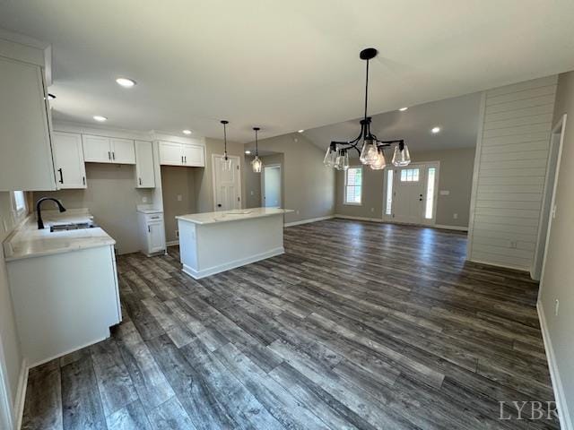 2304 Spring Grove Rd, Spout Spring, VA 24593 - kitchen with a kitchen island, a sink, dark wood-style floors, baseboards, and white cabinets