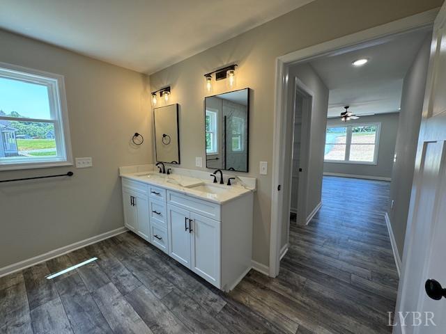 2304 Spring Grove Rd, Spout Spring, VA 24593 - full bathroom featuring double vanity, wood finished floors, and baseboards