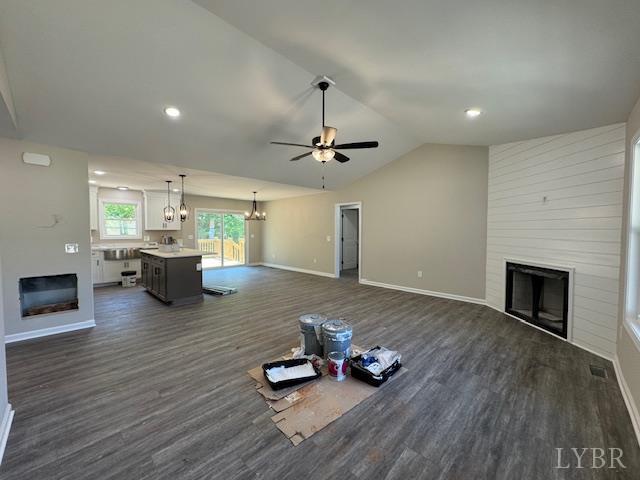 2350 Spring Grove Rd, Spout Spring, VA 24593 - unfurnished living room with a fireplace, a chandelier, dark wood-type flooring, vaulted ceiling, and recessed lighting