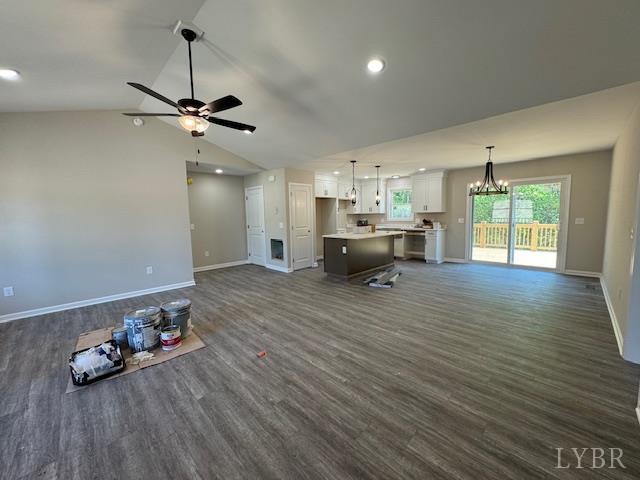 2350 Spring Grove Rd, Spout Spring, VA 24593 - unfurnished living room featuring dark wood finished floors, baseboards, a chandelier, ceiling fan, and vaulted ceiling