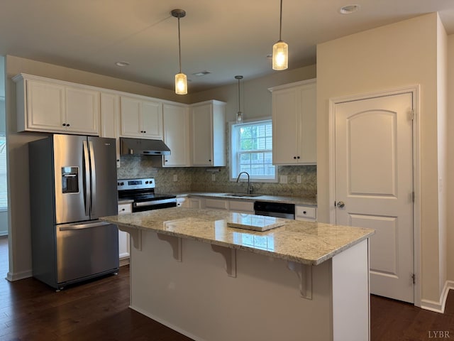 1049 Old Trail Rd, Forest, VA 24551 - kitchen featuring appliances with stainless steel finishes, under cabinet range hood, a sink, dark wood-type flooring, and backsplash