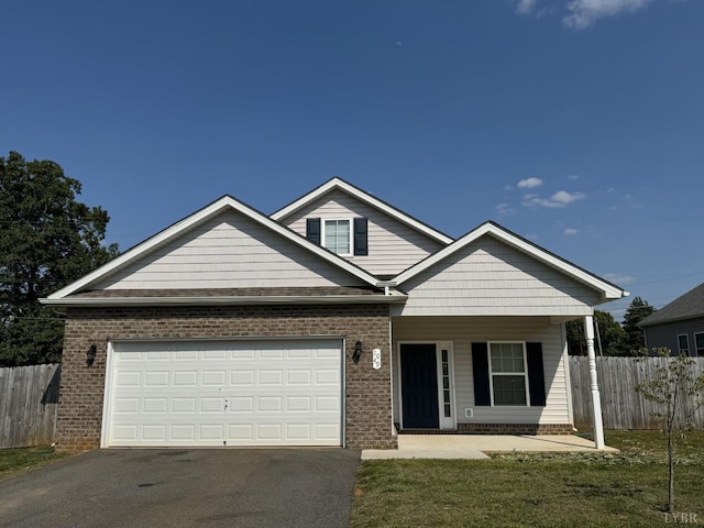 1049 Old Trail Rd, Forest, VA 24551 - view of front of property with asphalt driveway, a garage, brick siding, and a porch