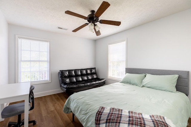 100 Capstone Dr Unit 207, Lynchburg, VA 24502 - bedroom with wood finished floors, multiple windows, a textured ceiling, and a ceiling fan