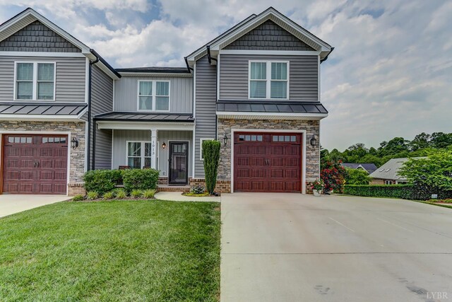 1013 Cobblestone Ln, Forest, VA 24551 - craftsman house with driveway, a standing seam roof, a garage, a front lawn, and stone siding