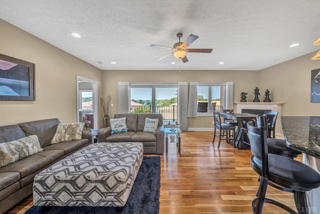 1066 Siesta Key Ct, Moneta, VA 24121 - living room featuring light wood-style floors, ceiling fan, a textured ceiling, recessed lighting, and baseboards