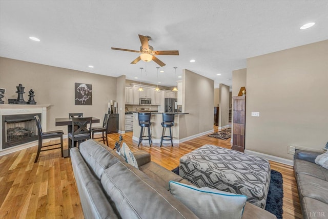1066 Siesta Key Ct, Moneta, VA 24121 - living area featuring ceiling fan, baseboards, light wood-type flooring, a fireplace, and recessed lighting
