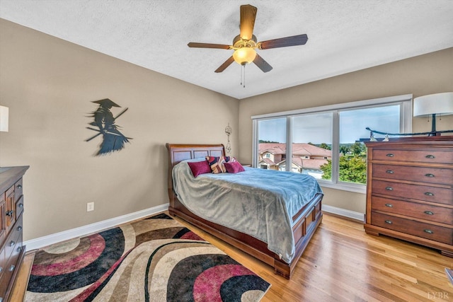 1066 Siesta Key Ct, Moneta, VA 24121 - bedroom with baseboards, light wood finished floors, a textured ceiling, and ceiling fan