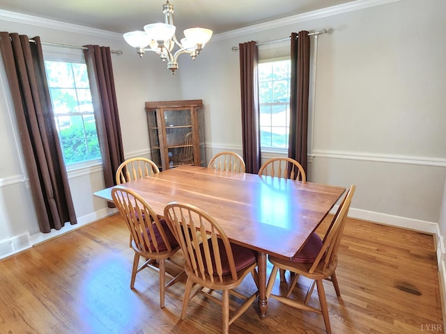 610 Dumas St, Lynchburg, VA 24502 - dining space featuring a chandelier, crown molding, light wood-type flooring, and baseboards