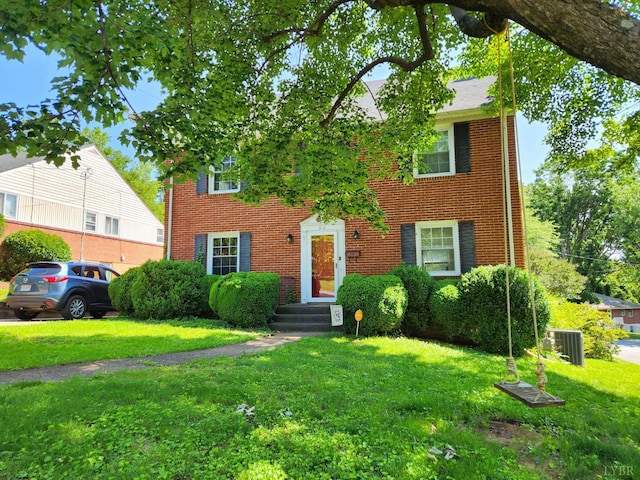610 Dumas St, Lynchburg, VA 24502 - view of front facade featuring a front yard, cooling unit, and brick siding