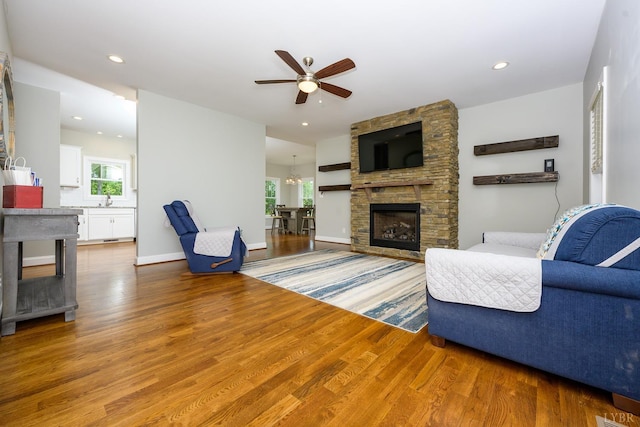 1032 Wiggington Rd, Lynchburg, VA 24502 - living room featuring a fireplace, wood finished floors, a ceiling fan, recessed lighting, and a chandelier