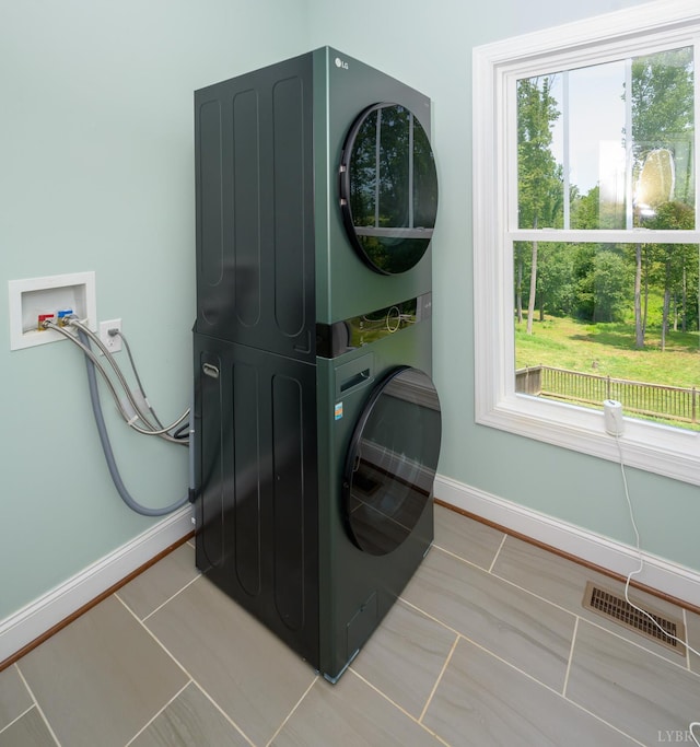 1032 Wiggington Rd, Lynchburg, VA 24502 - laundry area featuring stacked washer / dryer and tile patterned floors