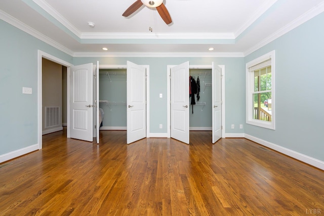 1032 Wiggington Rd, Lynchburg, VA 24502 - unfurnished bedroom featuring multiple closets, wood finished floors, crown molding, a raised ceiling, and a ceiling fan