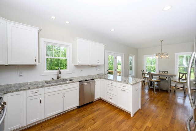 1032 Wiggington Rd, Lynchburg, VA 24502 - kitchen with stainless steel dishwasher, white cabinetry, a peninsula, wood finished floors, and recessed lighting