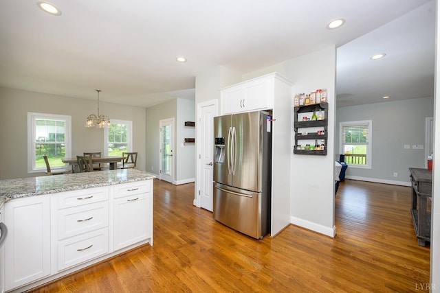 1032 Wiggington Rd, Lynchburg, VA 24502 - kitchen with stainless steel refrigerator with ice dispenser, wood finished floors, white cabinets, plenty of natural light, and recessed lighting