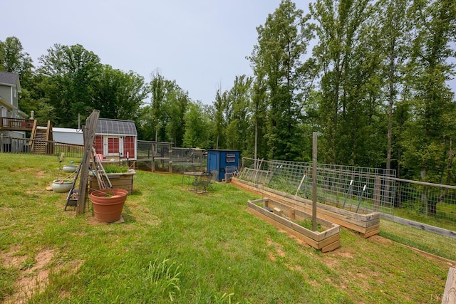 1032 Wiggington Rd, Lynchburg, VA 24502 - view of yard featuring a vegetable garden and a storage shed