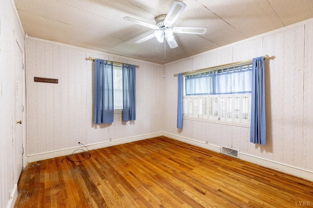1094 Pigeon Run Rd, Gladys, VA 24554 - empty room featuring crown molding, wood finished floors, a ceiling fan, baseboards, and wooden walls