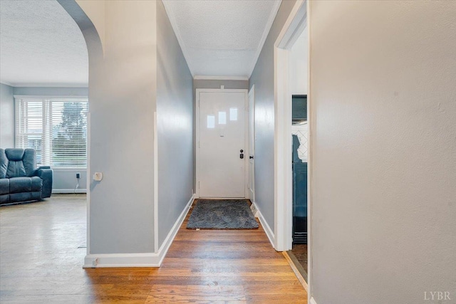 909 Lake Dr, Bedford, VA 24523 - hall with a textured ceiling, arched walkways, wood finished floors, and baseboards