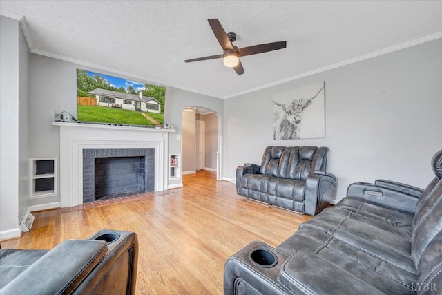 909 Lake Dr, Bedford, VA 24523 - living area featuring a ceiling fan, arched walkways, wood finished floors, crown molding, and baseboards