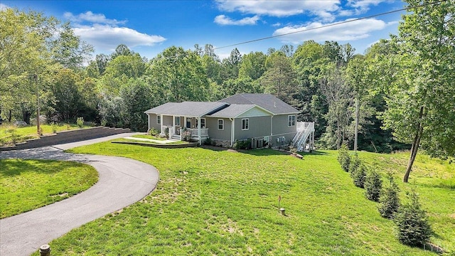 1620 Stripers Cove Rd, Goodview, VA 24095 - ranch-style home with covered porch, a front lawn, asphalt driveway, and a forest view