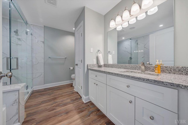 1620 Stripers Cove Rd, Goodview, VA 24095 - full bath with a marble finish shower, toilet, vanity, wood finished floors, and recessed lighting
