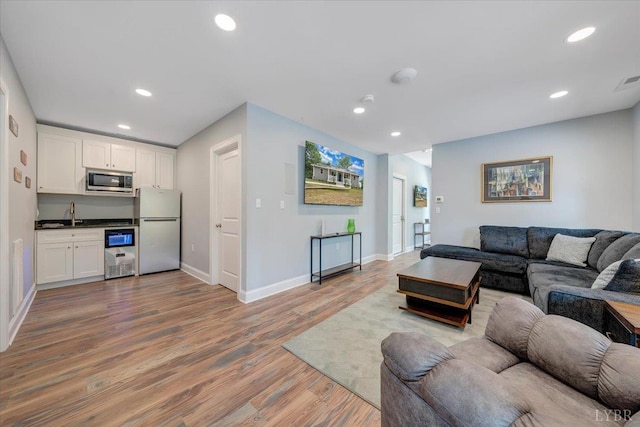 1620 Stripers Cove Rd, Goodview, VA 24095 - living area featuring light wood finished floors, baseboards, and recessed lighting
