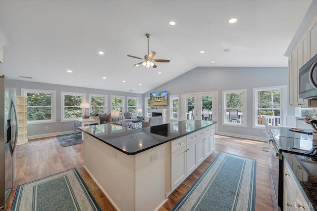 1620 Stripers Cove Rd, Goodview, VA 24095 - kitchen featuring a ceiling fan, stainless steel fridge, white cabinets, vaulted ceiling, and wood finished floors