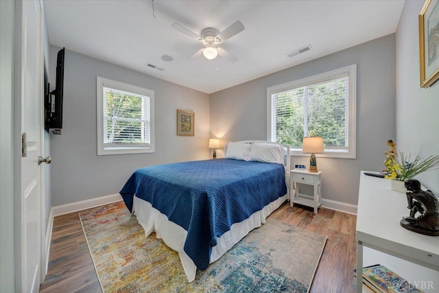 1620 Stripers Cove Rd, Goodview, VA 24095 - bedroom with multiple windows, baseboards, wood finished floors, and a ceiling fan