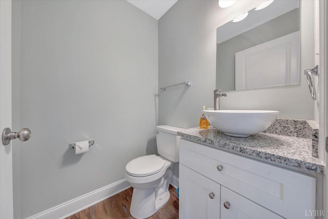 1620 Stripers Cove Rd, Goodview, VA 24095 - bathroom featuring vanity, wood finished floors, toilet, and baseboards