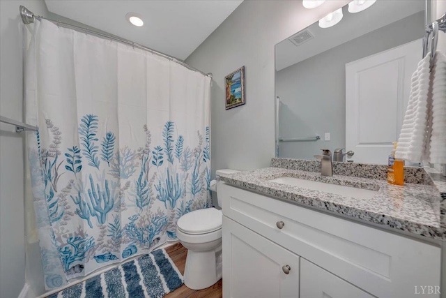 1620 Stripers Cove Rd, Goodview, VA 24095 - full bathroom with vanity, toilet, wood finished floors, and a shower with shower curtain