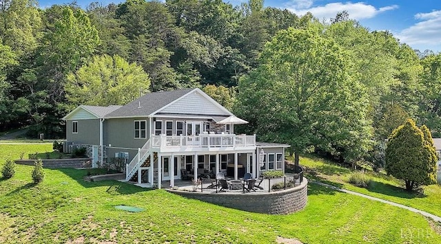 1620 Stripers Cove Rd, Goodview, VA 24095 - rear view of house with a patio, a wooden deck, stairway, a lawn, and a forest view